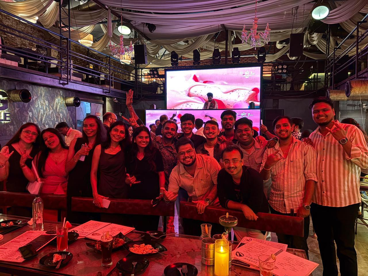 Scale Up team celebrating quarterly profit milestone over dinner